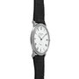 The Patek Philippe Calatrava is shown from the side, featuring a silver case, white dial with black Roman numerals, and a black leather strap.