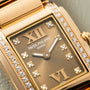 Close-up of a Patek Philippe Twenty-4 gold watch featuring diamond accents and Roman numerals on the dial.