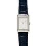 The Jaeger-LeCoultre Reverso Classique Ladies watch features a rectangular silver case, diamond accents, blue leather strap, and displays 12:00 on the dial.