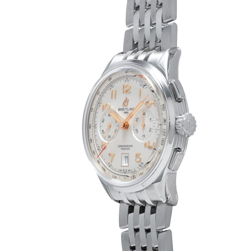 The Breitling B01 Premier Chronograph 42 features a silver metal link band, white dial, gold accents, and chronograph functions.