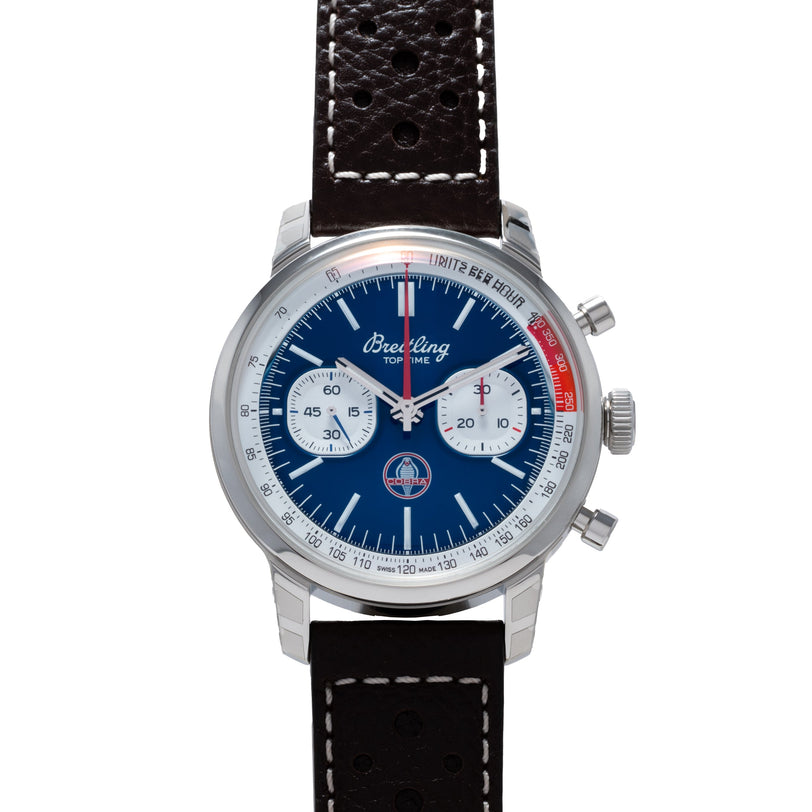 A Breitling Top Time B01 Chronograph Shelby Cobra wristwatch featuring a blue dial, black perforated leather strap, and three subdials.