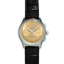 Breitling Premiere B09 Chronograph 40 watch featuring a gold dial, silver case, and black leather strap, shown from the front.