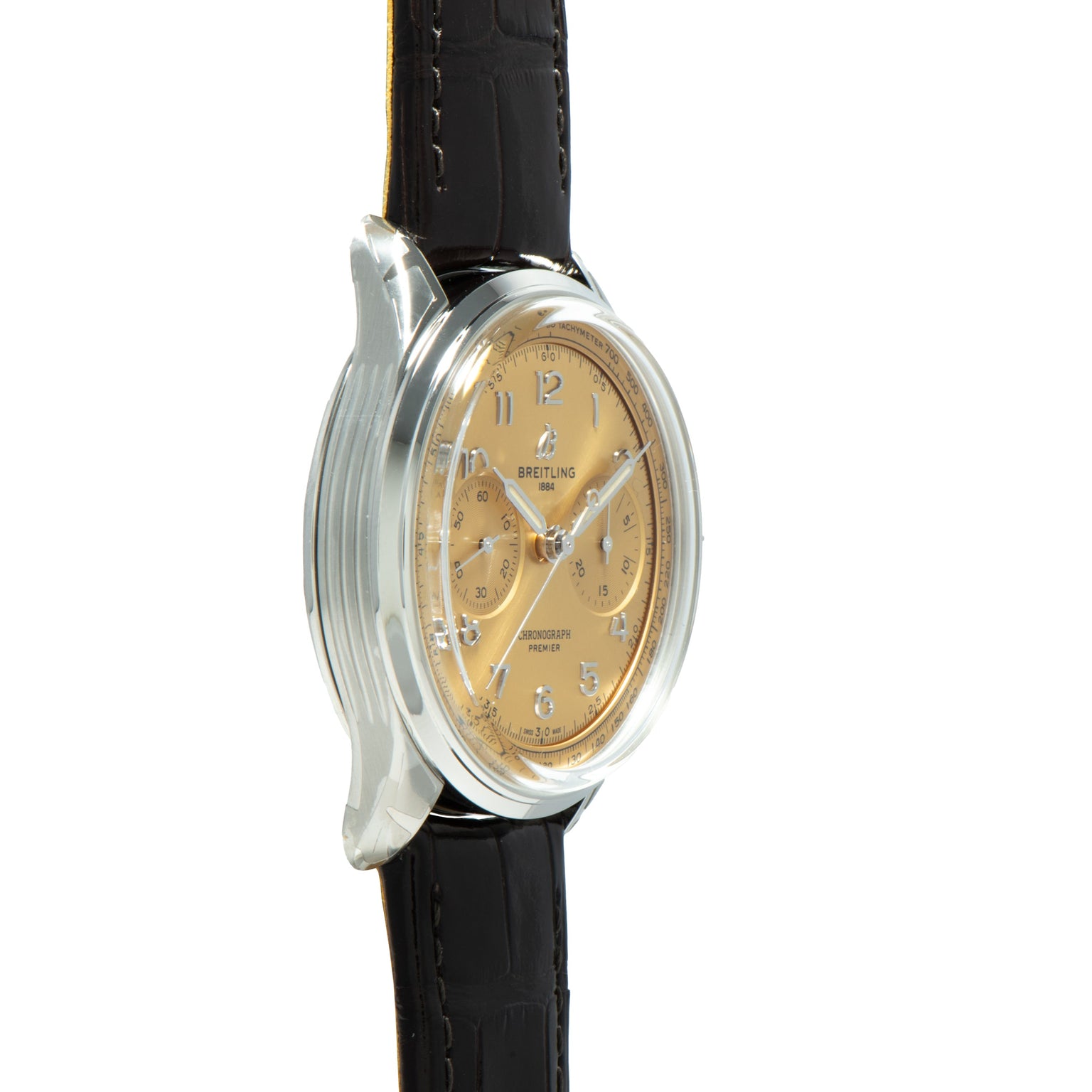 A Breitling Premiere B09 Chronograph 40 gold wristwatch with a black leather strap, shown from a side angle on a white background.