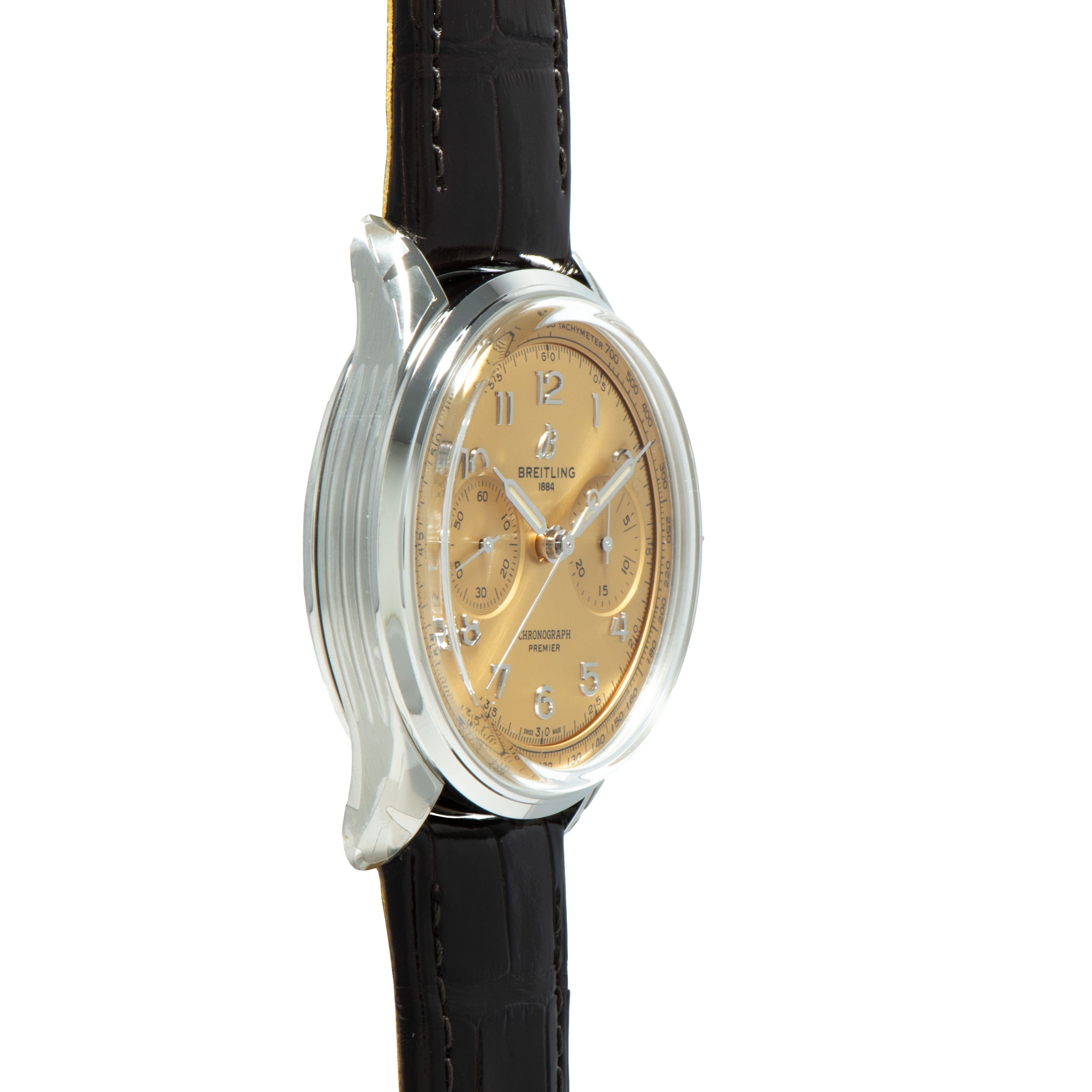 A Breitling Premiere B09 Chronograph 40 gold wristwatch with a black leather strap, shown from a side angle on a white background.
