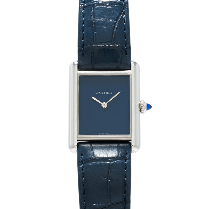 The Cartier Tank Must features a rectangular blue face, silver frame, and blue leather strap.