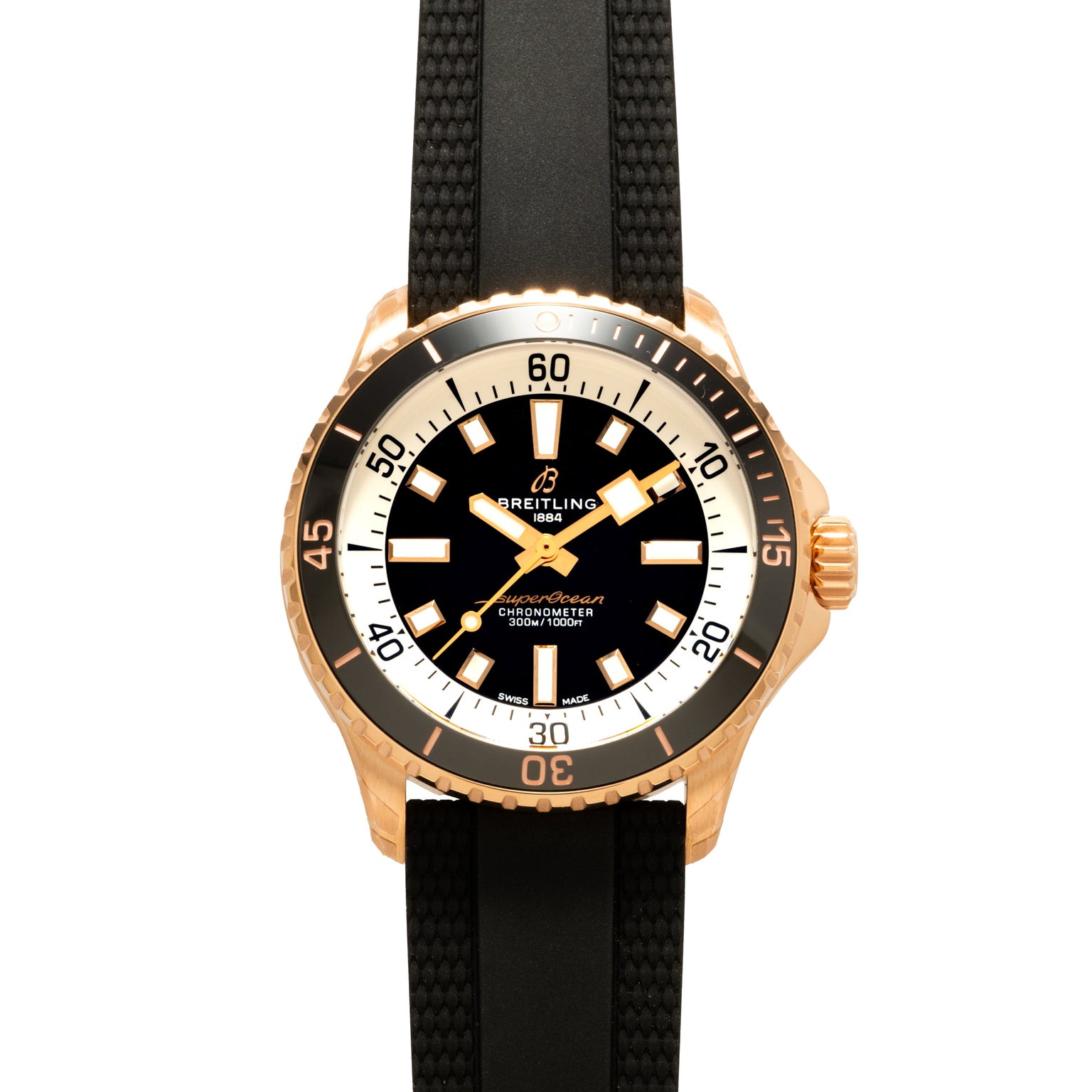 Breitling Superocean Automatic 42 gold dive watch with a black dial, white markers, and a black textured strap, viewed from above.