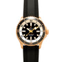 Breitling Superocean Automatic 42 gold dive watch with a black dial, white markers, and a black textured strap, viewed from above.
