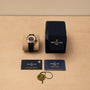 A Breitling Superocean Automatic 42 with box, warranty cards, and branded tag displayed on a beige surface.