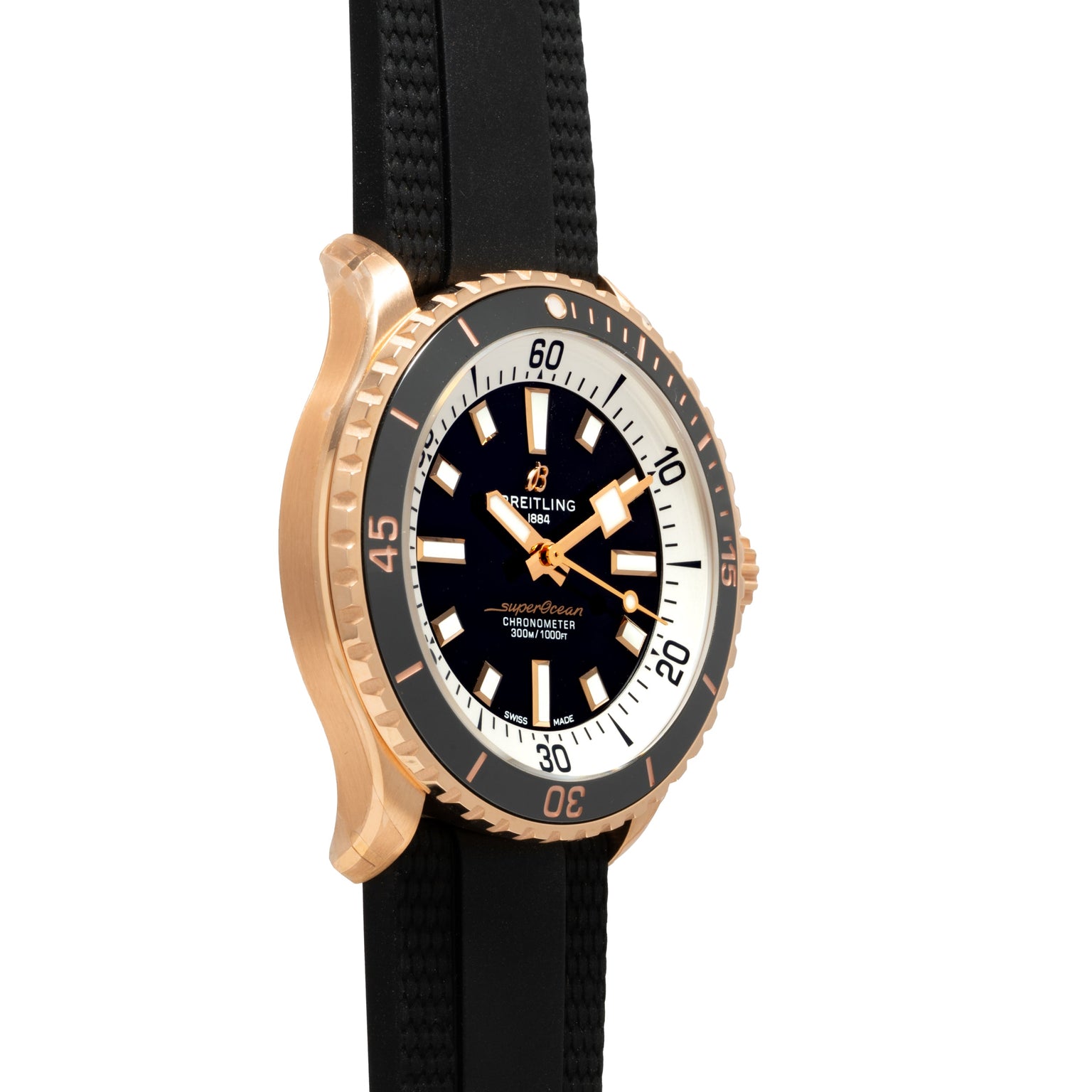 Side view of the Breitling Superocean Automatic 42 dive watch featuring a black strap, gold-tone case, and a black and white bezel.