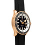 Side view of the Breitling Superocean Automatic 42 dive watch featuring a black strap, gold-tone case, and a black and white bezel.