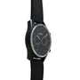 Zenith Chronomaster El Primero watch with dark dial, chronograph subdials, and black rubber strap.