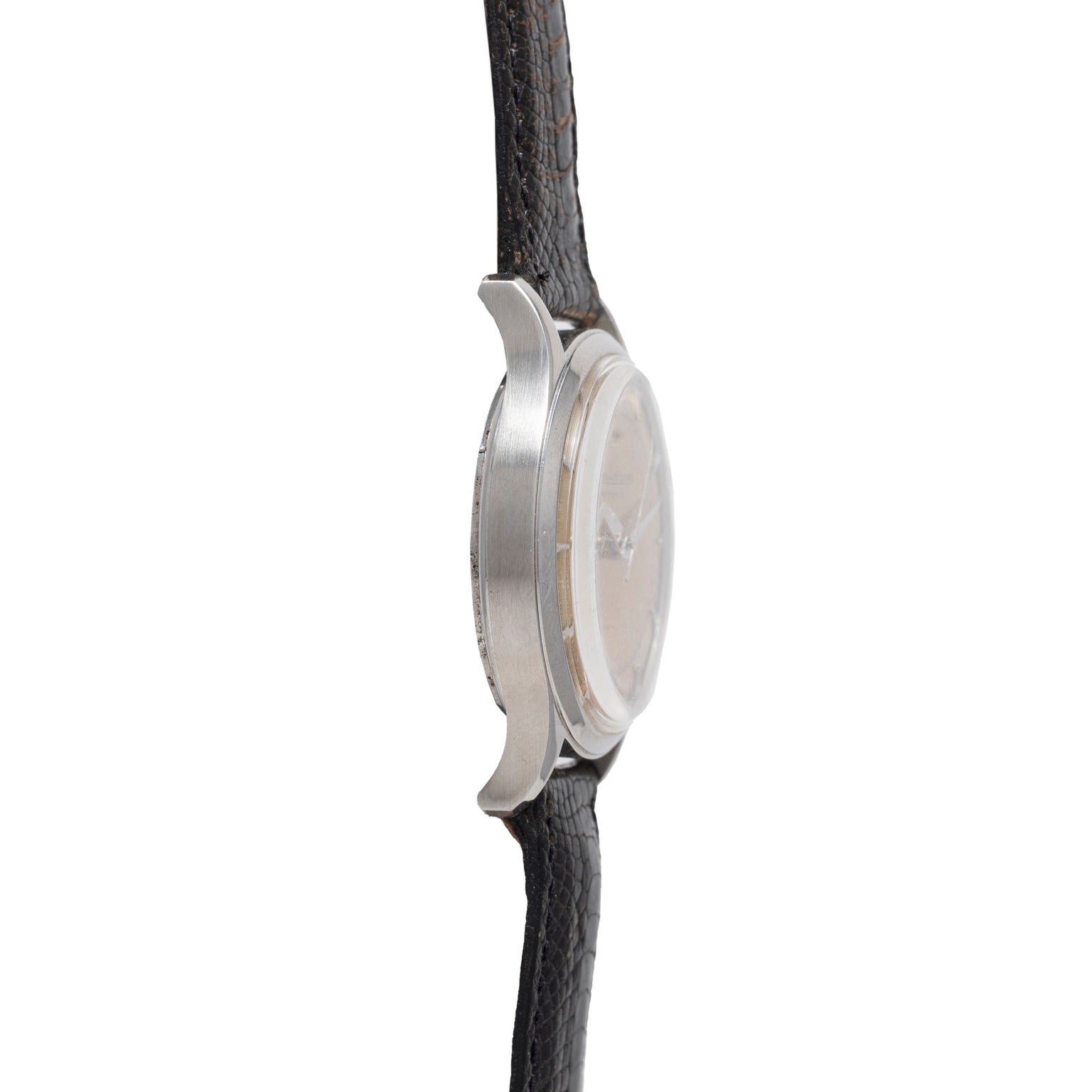 Side view of a Jaeger LeCoultre 'European Market' Powermatic dress watch, showing the round silver case and textured black leather strap, with focus on the case thickness and lugs; the watch face is not visible.