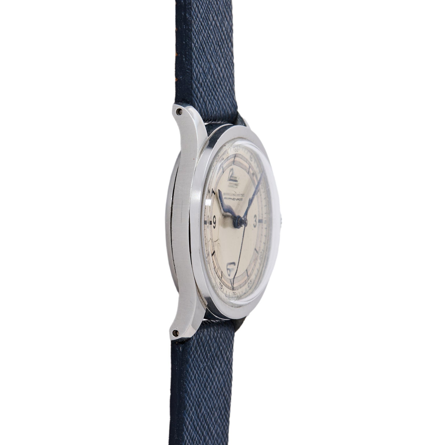 A side view of the Movado 'Calatrava' Steel shows its silver case, cream dial, and navy blue textured strap with dark hour markers and hands, displayed against a white background.