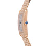 A close-up side view of the Cartier Tank Americaine by Cartier, a ladies’ 18K rose gold watch featuring a silver guilloché dial with Roman numerals, blue gemstone crown, and gold link bracelet.