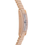 Side view of a Cartier Tank Americaine ladies wristwatch in 18K rose gold with a silver guilloché dial, Roman numerals, linked bracelet, visible case screws, and the Cartier logo subtly on the dial.