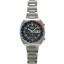 Seiko chronograph with black dial, blue and red tachymeter bezel, day-date window, and stainless steel bracelet.