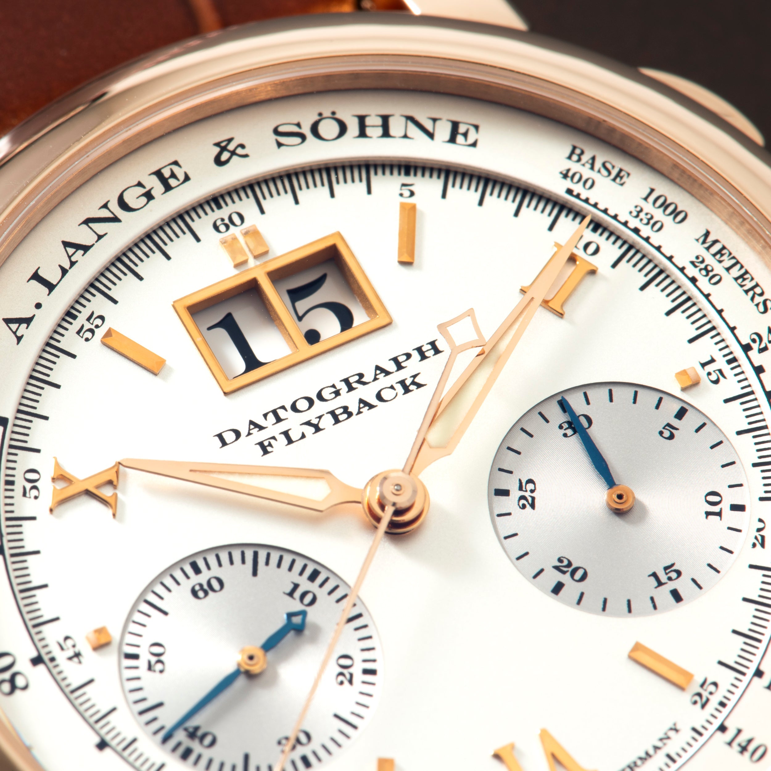 A. Lange & Söhne Datograph chronograph watch with rose gold case, white dial, jump hour display, and two subdials.