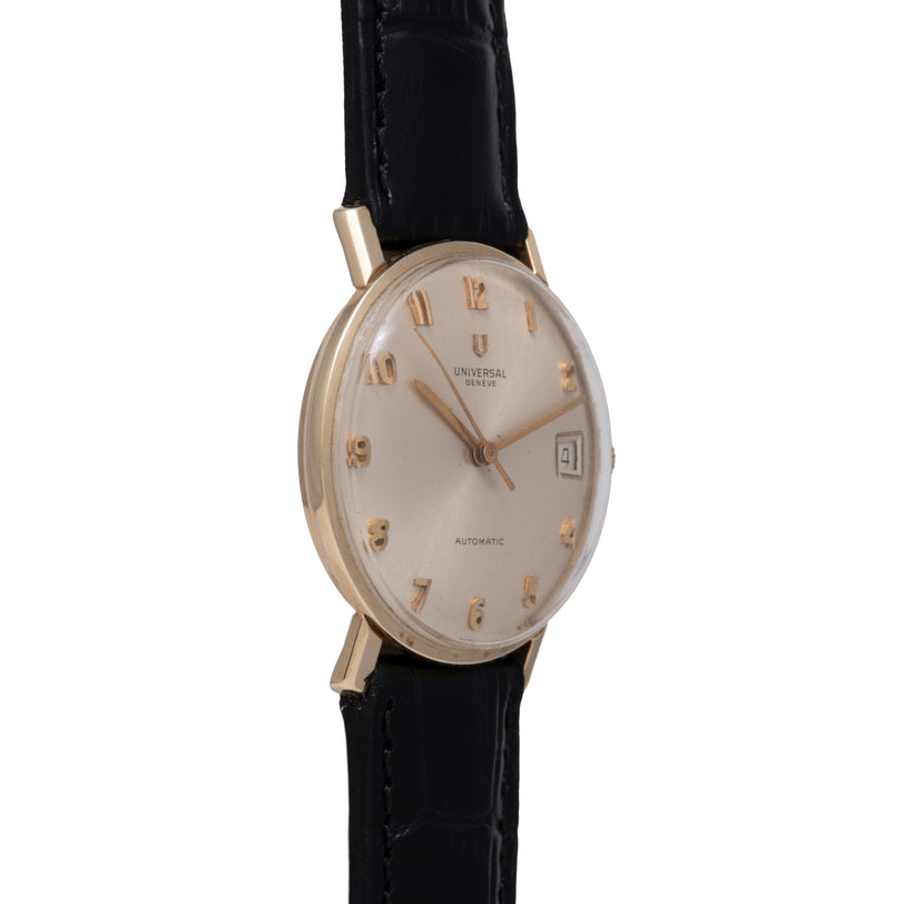 Universal Geneve Calatrava watch with silver dial, gold-tone numerals, date window, and black leather strap.