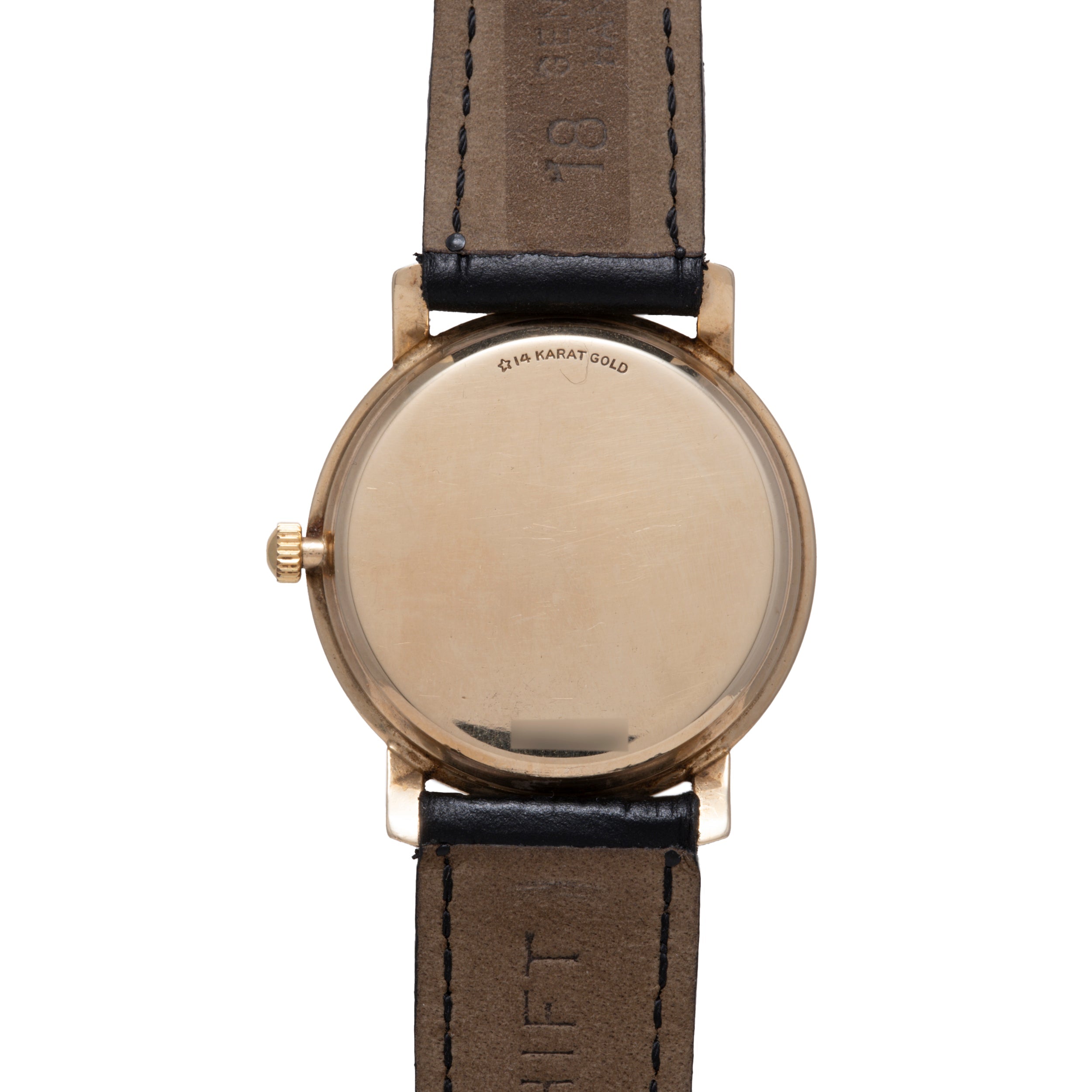 14 karat gold watch with round case, blank dial, and dark leather strap with visible stitching.