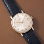 Universal Geneve automatic wristwatch with cream dial, gold applied numerals and hands, date window, and black crocodile leat