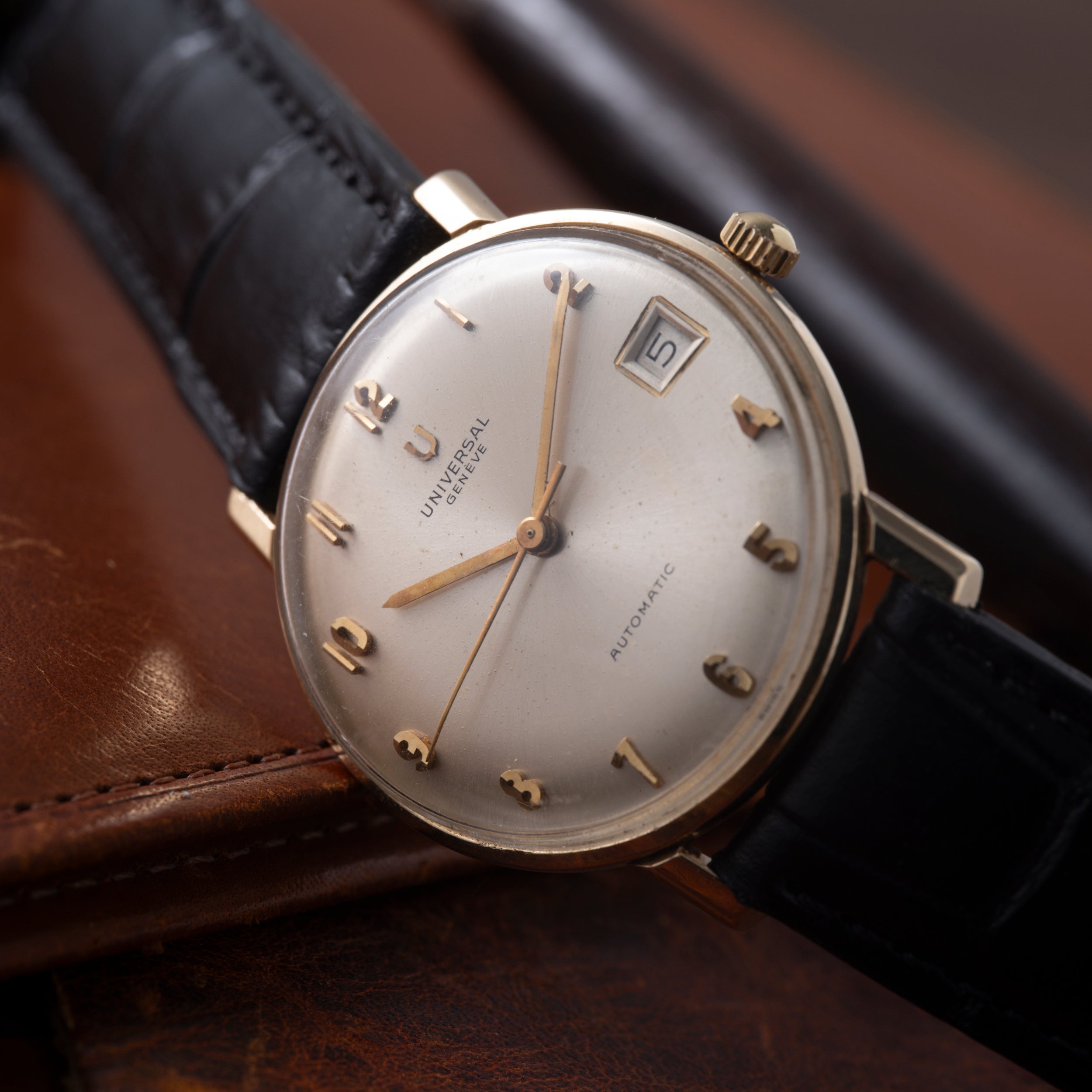 Universal Geneve Calatrava automatic watch with silver dial, gold-tone hands and indices, date window, on black leather strap