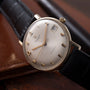 Universal Geneve Calatrava automatic watch with silver dial, gold-tone hands and indices, date window, on black leather strap