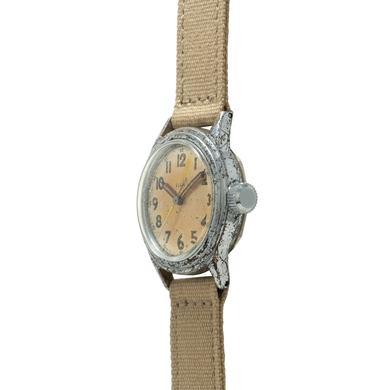 Vintage Elgin wristwatch with cream dial, Arabic numerals, weathered metal case, and tan fabric strap.