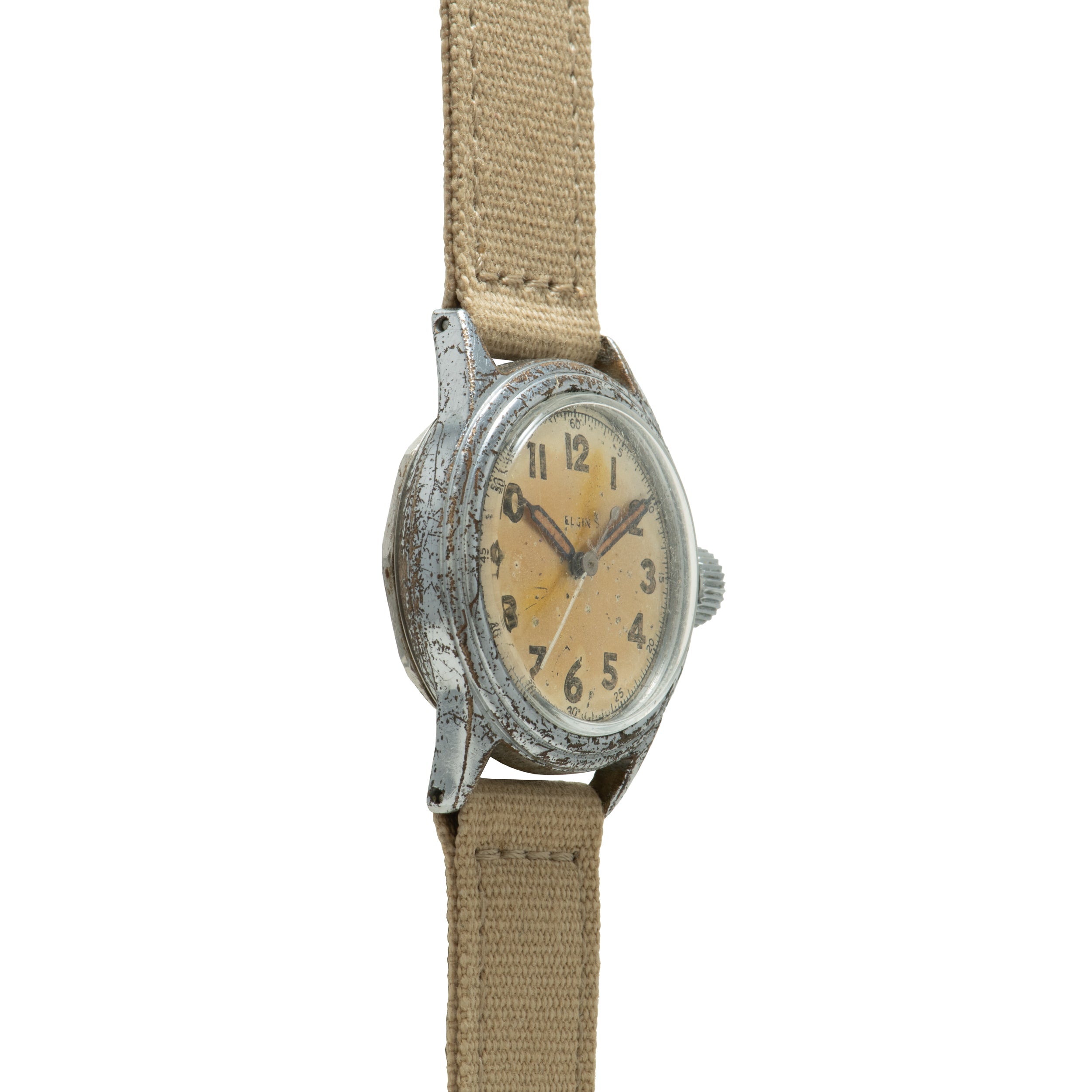 Vintage Elgin watch with patinated silver case, cream dial, Arabic numerals, and tan canvas strap.