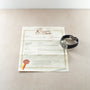 Patek Philippe Aquanaut watch with black rubber strap and silver dial displayed with certificate of authenticity.
