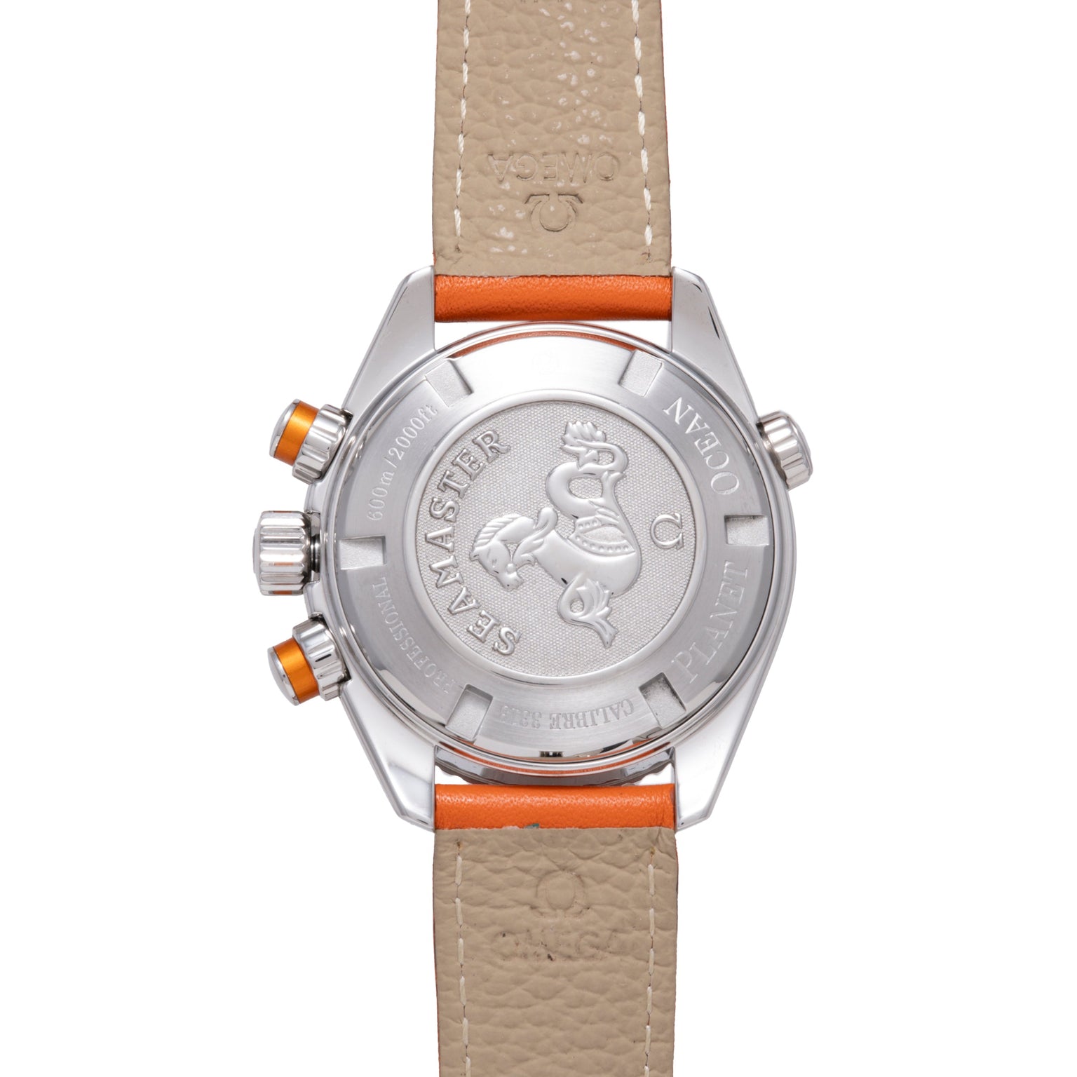 Stainless steel watch with beige and orange leather strap, visible caseback with sea creature emblem and orange pushers.