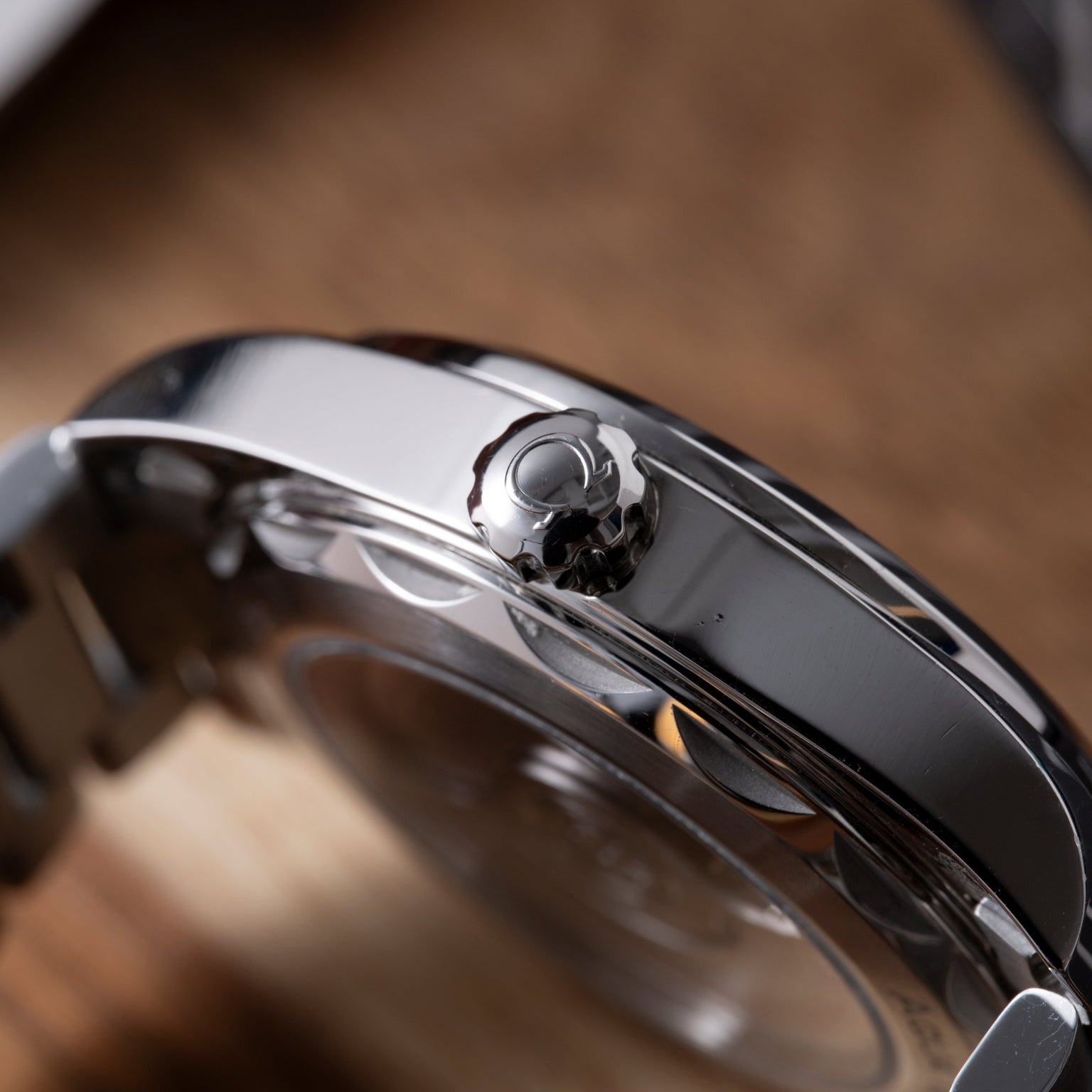 Black and silver sports watch with rounded crown and polished metal case shown in side profile.
