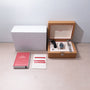 Omega Seamaster watch with blue dial, two interchangeable straps, operating instructions, and warranty card in wooden box wit