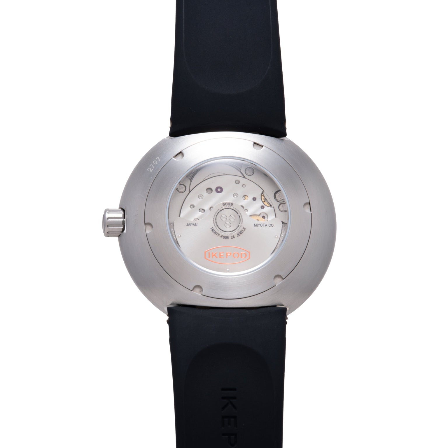Stainless steel round watch with visible mechanical movement on caseback, black rubber strap, and crown on side.