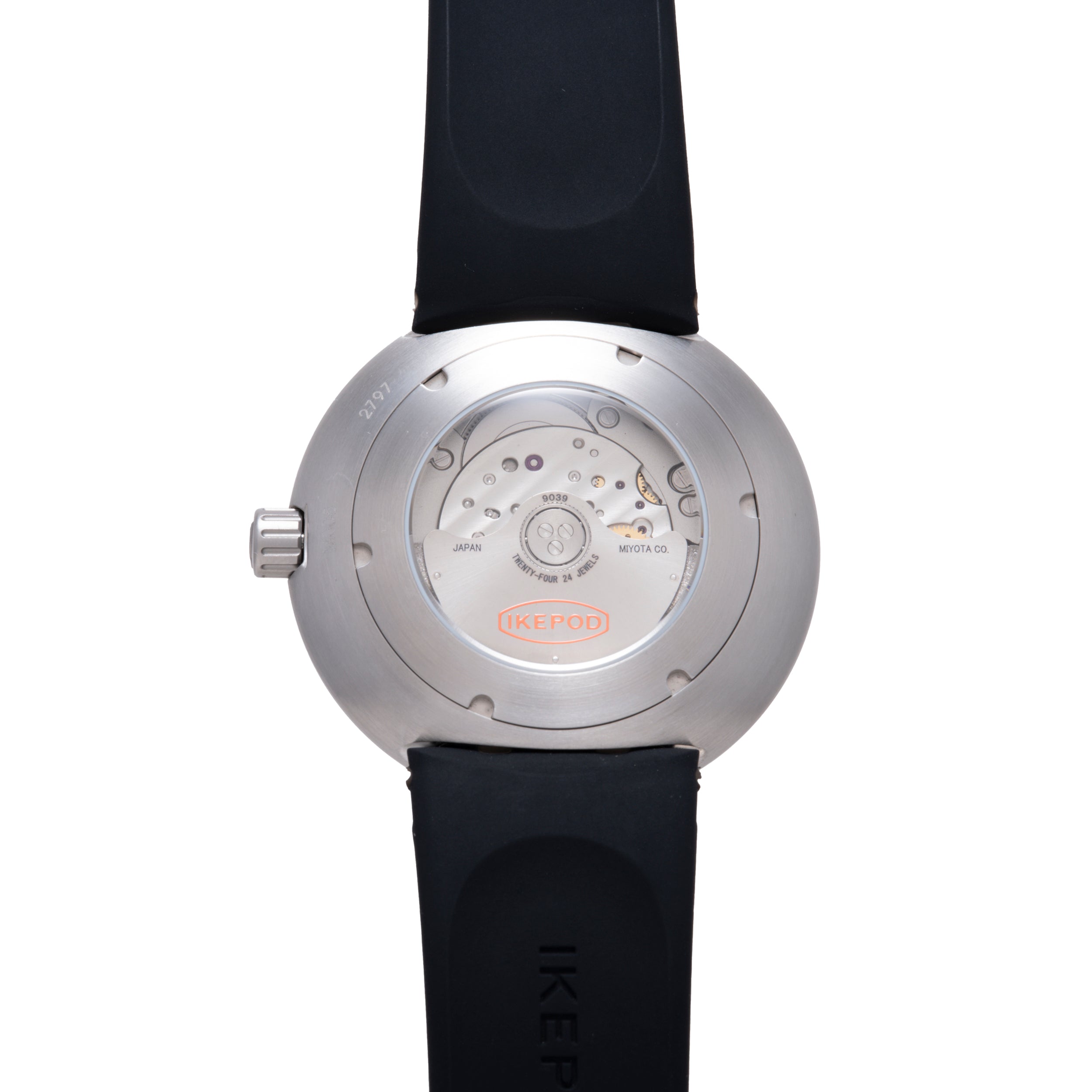 Stainless steel round watch with visible mechanical movement on caseback, black rubber strap, and crown on side.