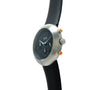 Ikepod Chronopod chronograph watch with brushed steel case, black dial, orange pushers, and black rubber strap.