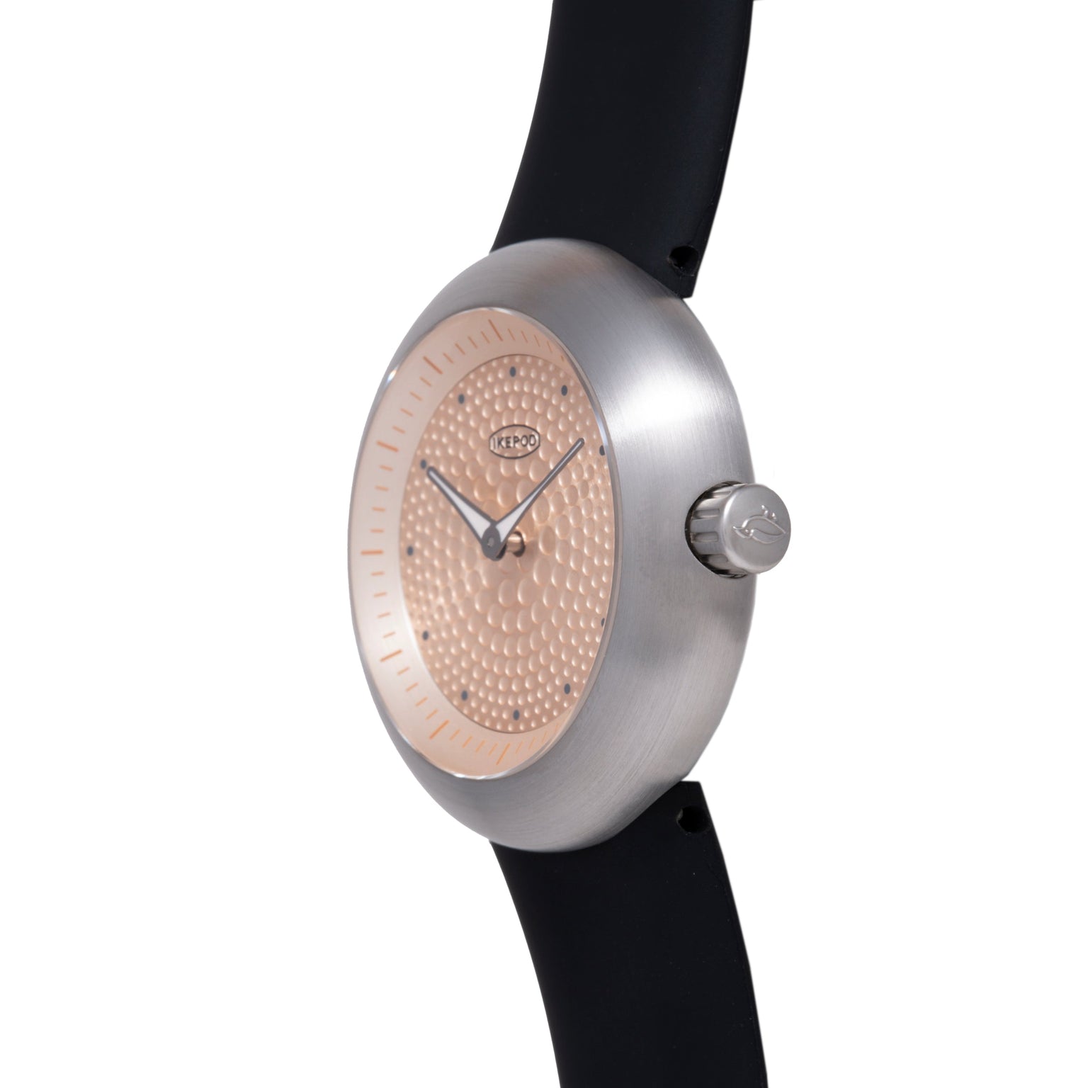 Ikepod Duopod watch with brushed silver case, rose gold textured dial with dot pattern, and black rubber strap.