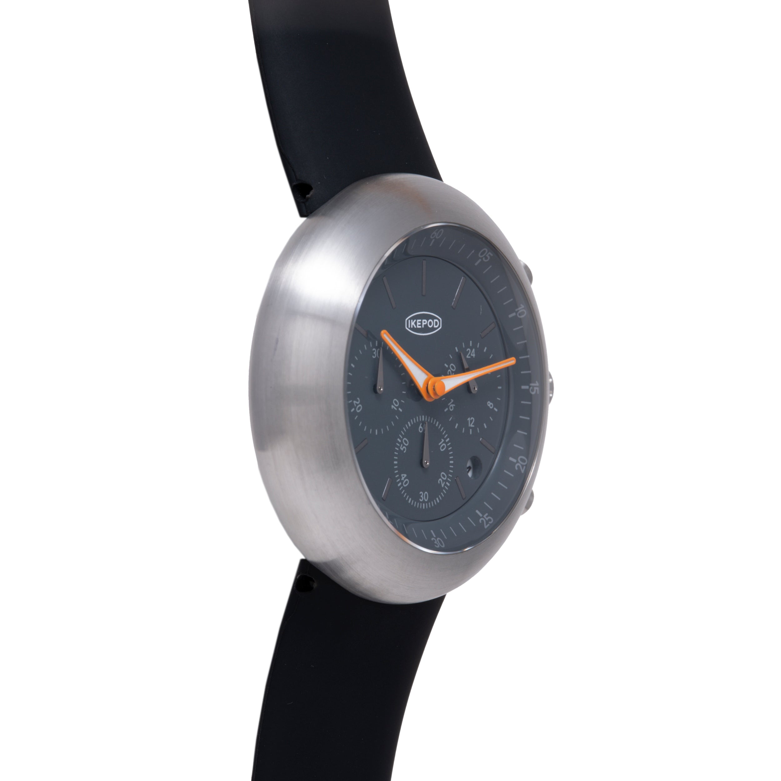 Ikepod Chronopod watch with brushed silver case, black dial, orange hands, and black rubber strap.
