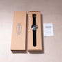 Ikepod Chronopod watch with black leather strap and blue dial in tan cardboard box with documentation.