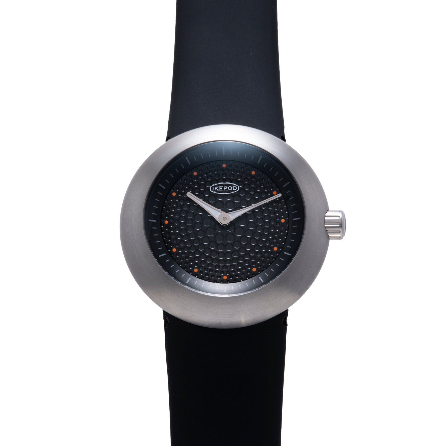 Ikepod watch with brushed metal case, black dial featuring orange dot markers, white hands, and black rubber strap.