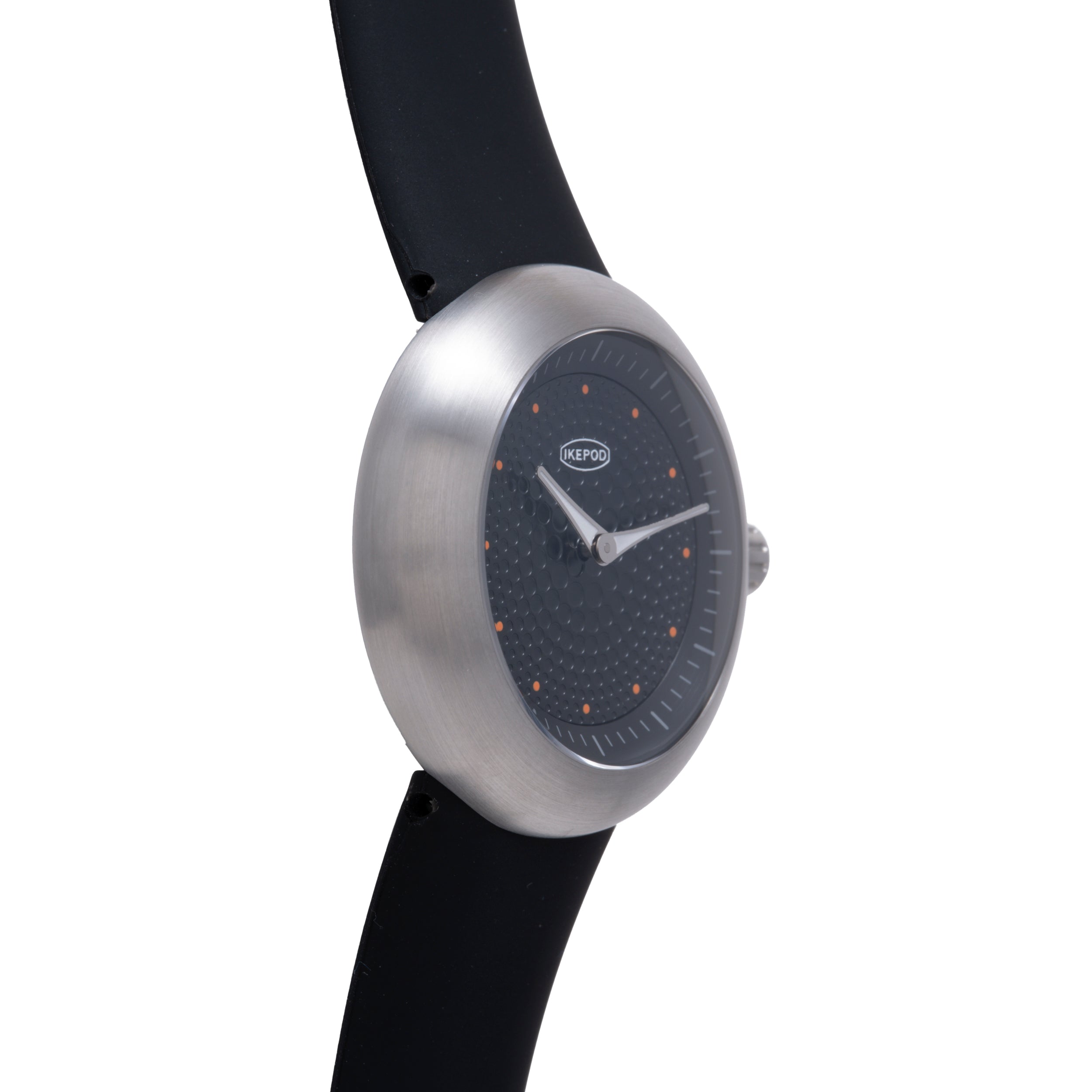 Ikepod Duopod Dots 004 watch with brushed silver case, black dial with orange dot markers, and black rubber strap.