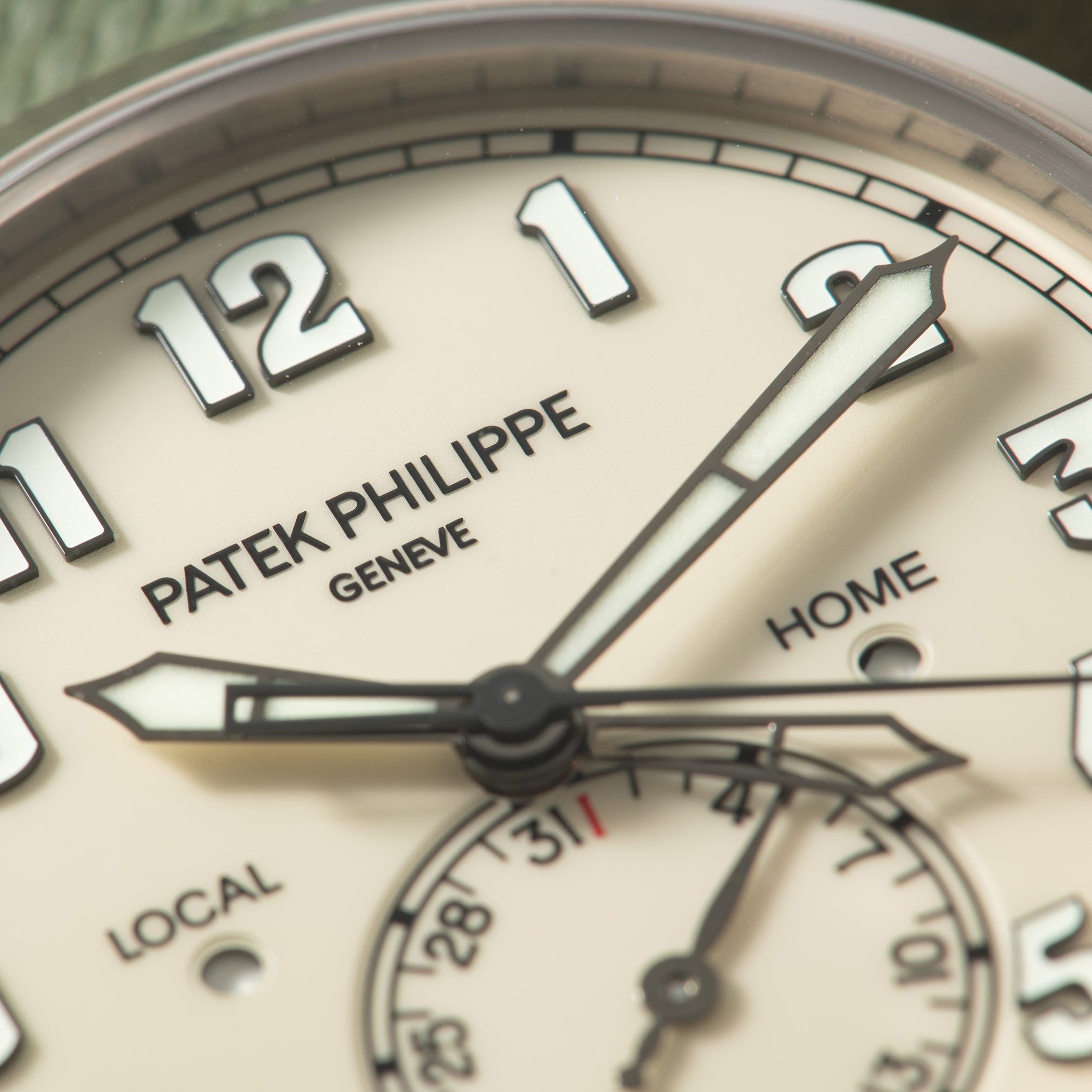 Patek Philippe Calatrava Pilot Travel Time watch dial showing hour markers, hands, and subdials labeled "Home," "Local," and