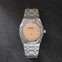 Stainless steel Audemars Piguet Royal Oak watch with salmon dial, applied indices, and integrated bracelet.