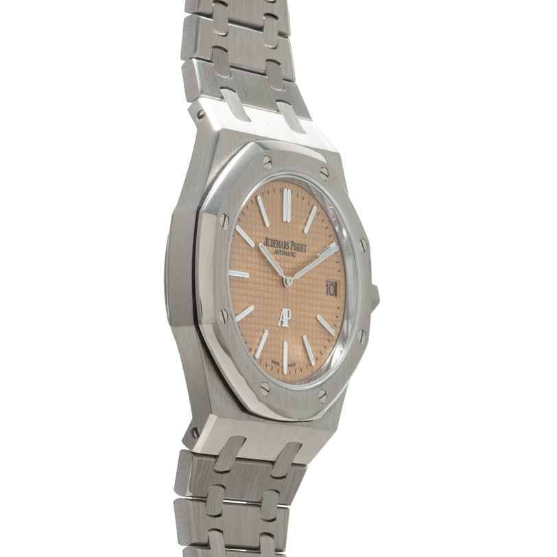Stainless steel watch with octagonal case, salmon-colored dial, white hour markers, and matching metal bracelet.