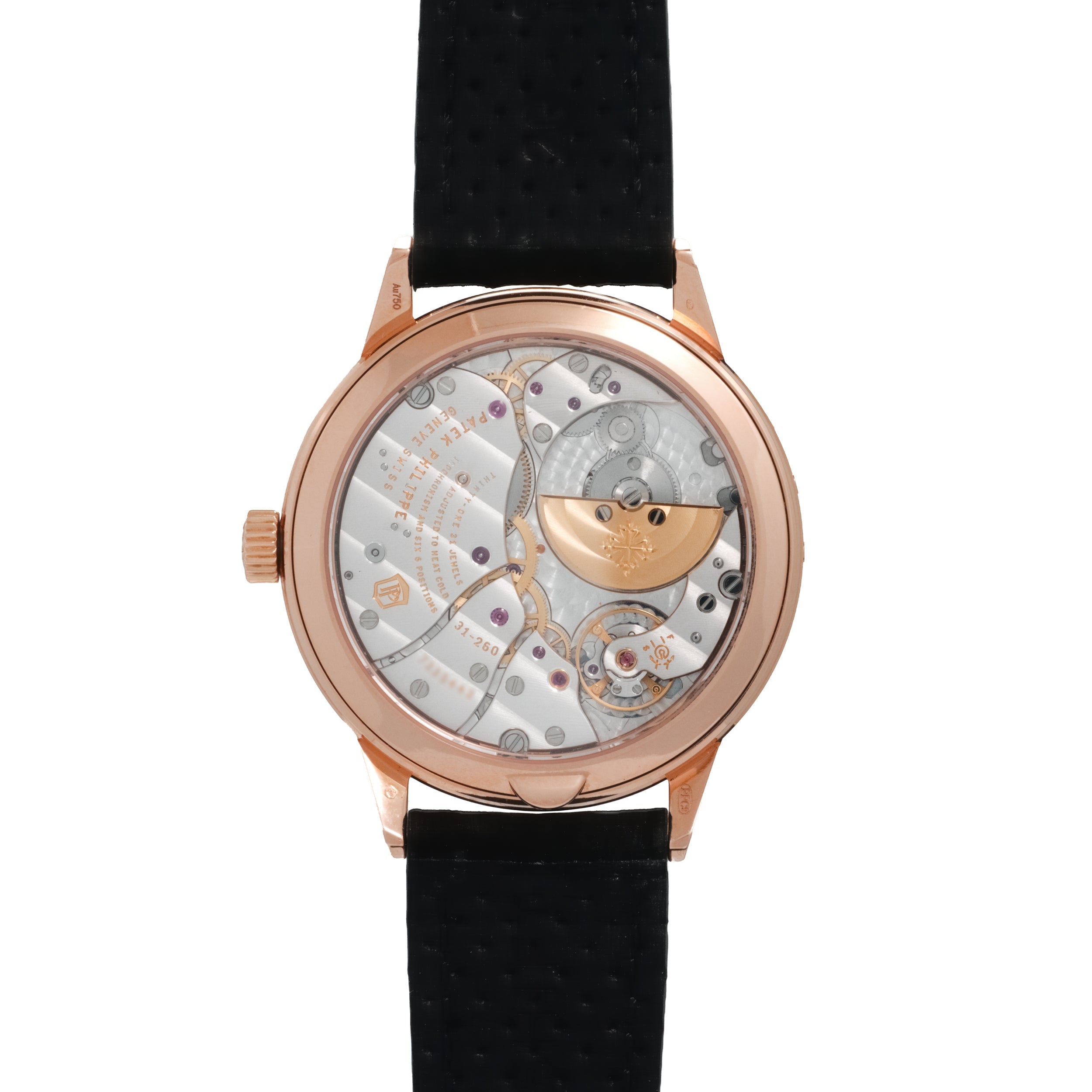 Rose gold watch with skeletonized dial showing mechanical movement, black leather strap, and exposed gears and balance wheel.