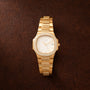 Gold-tone ladies watch with octagonal case, diamond-set bezel and bracelet, cream dial with date window.