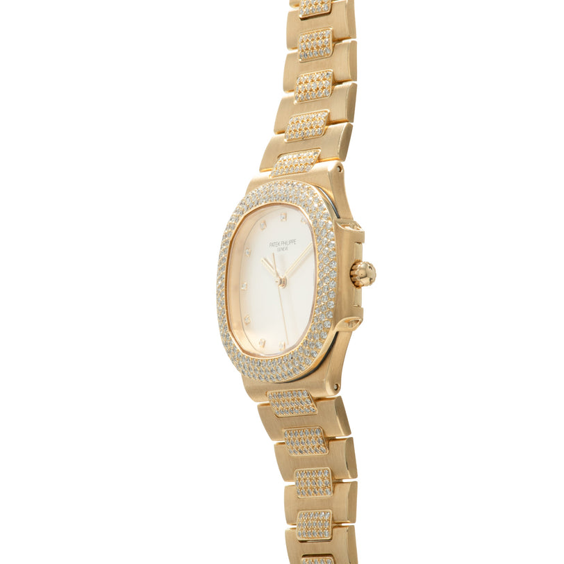 Gold-tone ladies watch with oval cream dial, diamond-set bezel and bracelet with rectangular links.