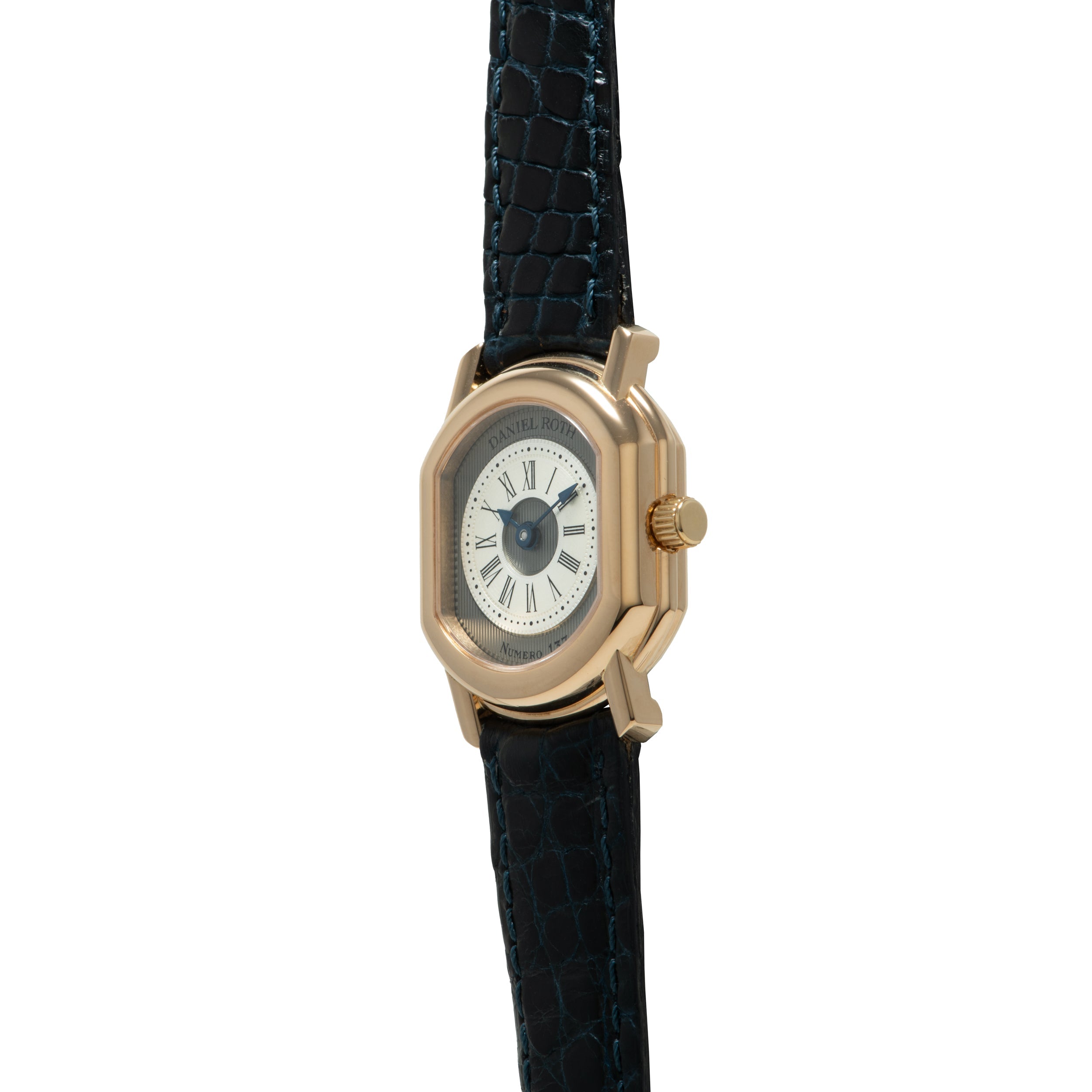 Gold-tone rectangular watch with cream dial, Roman numerals, and dark blue crocodile leather strap.