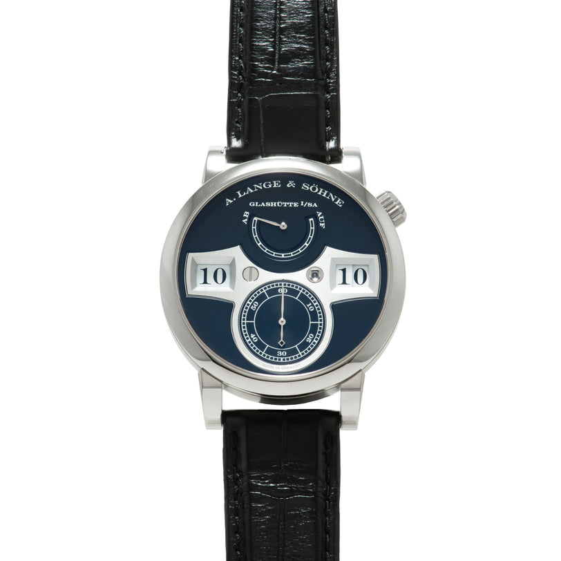 Silver-cased watch with dark blue dial featuring two white numeral windows displaying "10," a subsidiary seconds dial, and mo