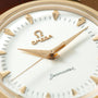 Omega Milano Cortina watch with white dial, gold-tone hour markers and hands, black minute indices, and Omega logo visible on