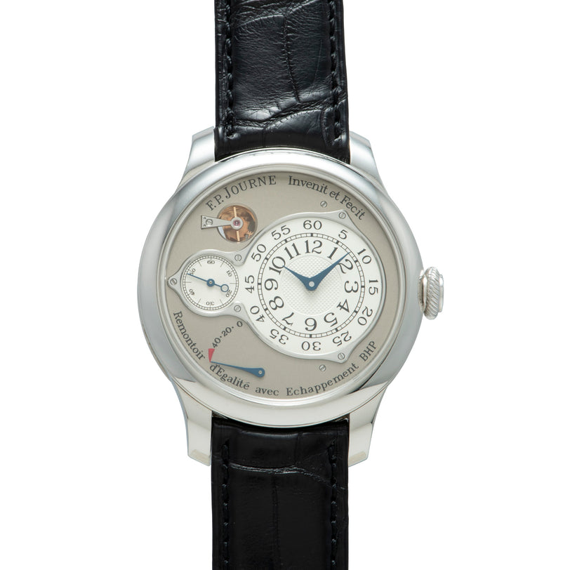 Silver-toned watch with cream dial, blue hands, subsidiary dials, and black leather strap.